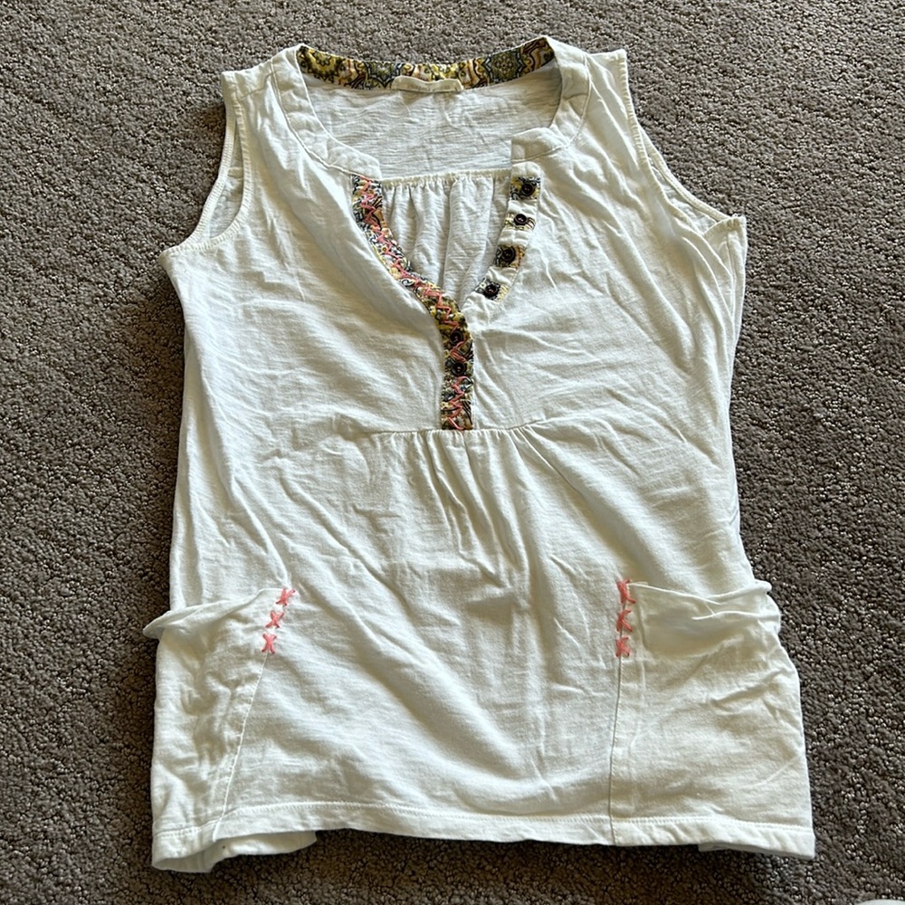 White tank with pocket and neckline details. Size small.